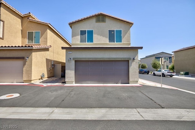 7212 Sunray Point St, North Las Vegas, NV 89084 - view of front of home featuring stucco siding, a garage, driveway, and a tile roof