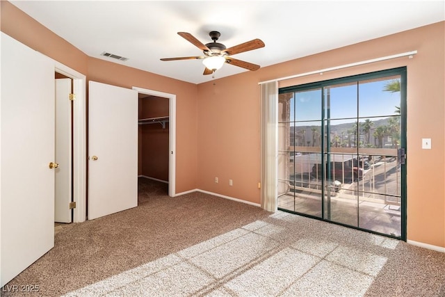1948 Las Palmas Ln Unit 277, Laughlin, NV 89029 - unfurnished bedroom with carpet, access to outside, ceiling fan, and a walk in closet