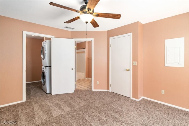 1948 Las Palmas Ln Unit 277, Laughlin, NV 89029 - unfurnished bedroom with stacked washer / drying machine, carpet flooring, ensuite bath, a ceiling fan, and a spacious closet