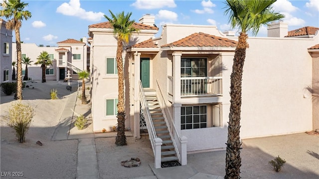 1948 Las Palmas Ln Unit 277, Laughlin, NV 89029 - view of front of home with stucco siding, stairway, a tiled roof, and a chimney