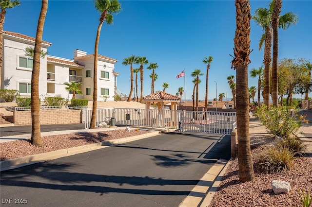 1948 Las Palmas Ln Unit 277, Laughlin, NV 89029 - view of front facade with a residential view, stucco siding, a gate, and a chimney