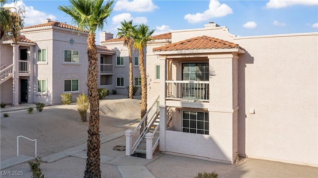 1948 Las Palmas Ln Unit 277, Laughlin, NV 89029 - view of front of home featuring stucco siding, a tiled roof, and stairs