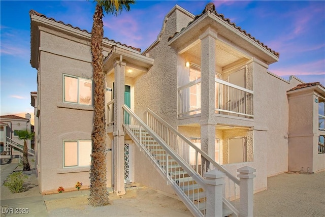 1948 Las Palmas Ln Unit 277, Laughlin, NV 89029 - view of front facade featuring stucco siding, a tile roof, a patio, and stairway