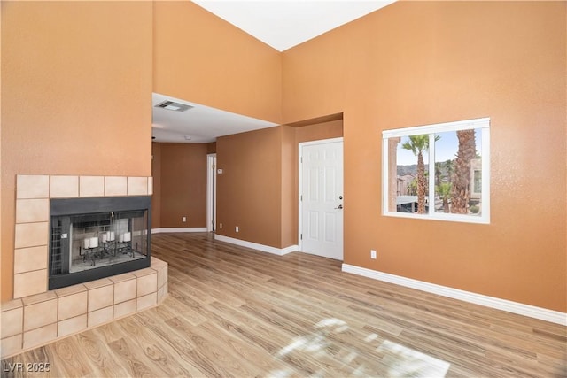 1948 Las Palmas Ln Unit 277, Laughlin, NV 89029 - unfurnished living room with a towering ceiling, wood finished floors, and a fireplace