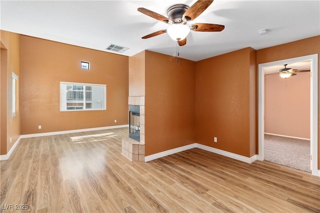 1948 Las Palmas Ln Unit 277, Laughlin, NV 89029 - spare room featuring a ceiling fan, a smoke detector, light wood-style flooring, and a tiled fireplace