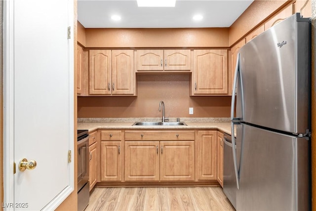1948 Las Palmas Ln Unit 277, Laughlin, NV 89029 - kitchen featuring appliances with stainless steel finishes, light brown cabinetry, light countertops, and light wood finished floors