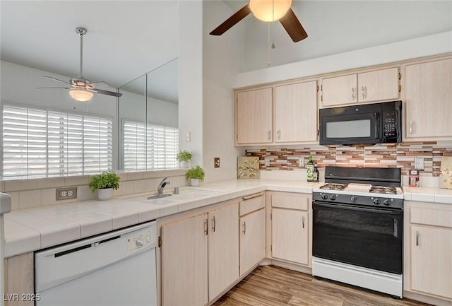 6201 E Lake Mead Blvd Unit 223, Las Vegas, NV 89156 - kitchen with ceiling fan, range with gas cooktop, dishwasher, black microwave, and backsplash