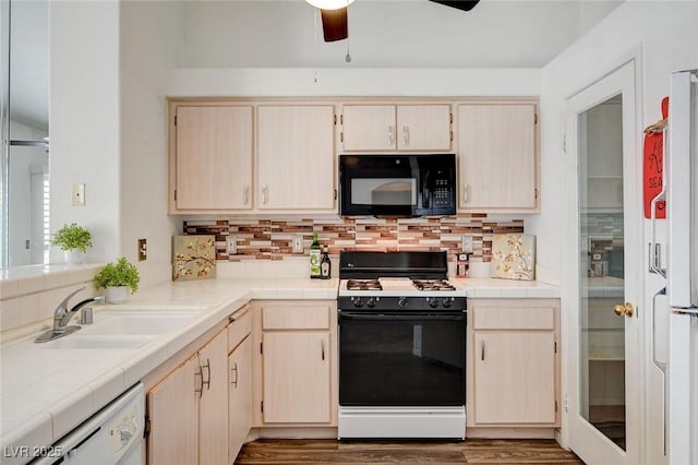 6201 E Lake Mead Blvd Unit 223, Las Vegas, NV 89156 - kitchen with black appliances, ceiling fan, decorative backsplash, wood finished floors, and light brown cabinetry