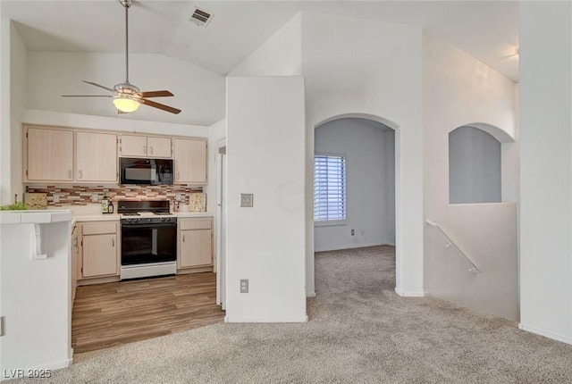 6201 E Lake Mead Blvd Unit 223, Las Vegas, NV 89156 - kitchen featuring light carpet, white range with gas cooktop, light countertops, black microwave, and ceiling fan