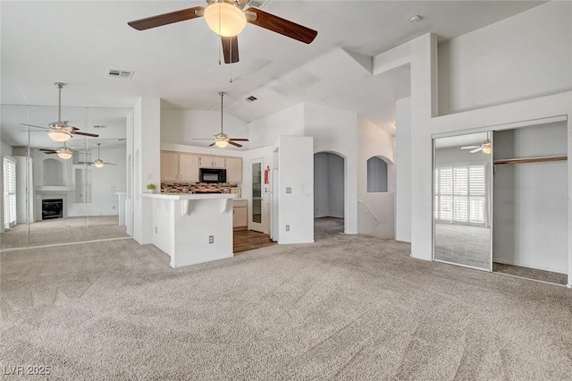 6201 E Lake Mead Blvd Unit 223, Las Vegas, NV 89156 - unfurnished living room with a ceiling fan, light carpet, high vaulted ceiling, and a fireplace