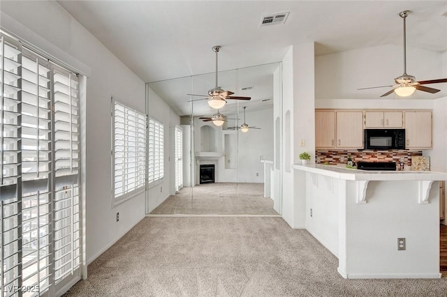6201 E Lake Mead Blvd Unit 223, Las Vegas, NV 89156 - kitchen featuring ceiling fan, tile countertops, and light colored carpet