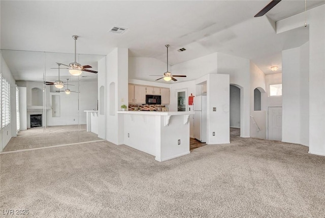 6201 E Lake Mead Blvd Unit 223, Las Vegas, NV 89156 - kitchen featuring ceiling fan, light carpet, open floor plan, a peninsula, and lofted ceiling