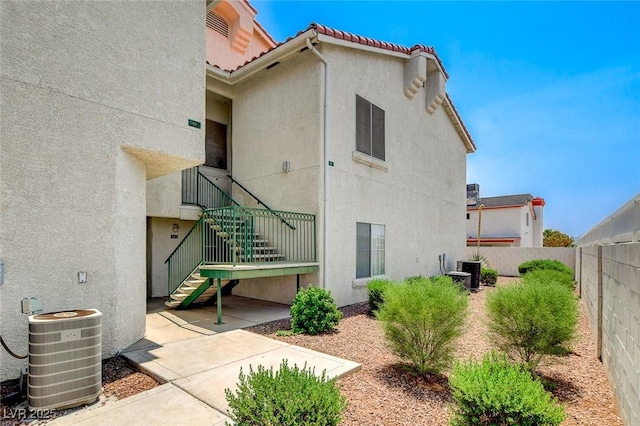 6201 E Lake Mead Blvd Unit 223, Las Vegas, NV 89156 - back of property with stucco siding, a fenced backyard, a tiled roof, and stairway