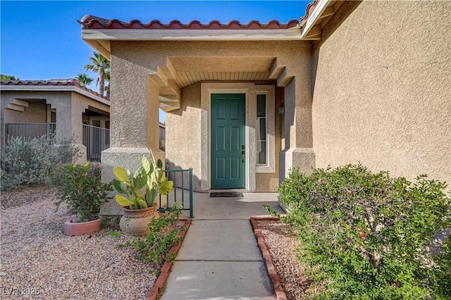 10612 Primrose Arbor Ave, Las Vegas, NV 89144 - property entrance with stucco siding and a tiled roof