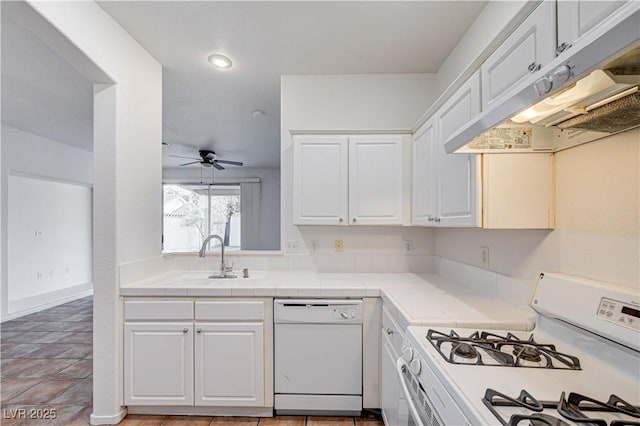 10612 Primrose Arbor Ave, Las Vegas, NV 89144 - kitchen with white appliances, under cabinet range hood, tile counters, white cabinetry, and recessed lighting