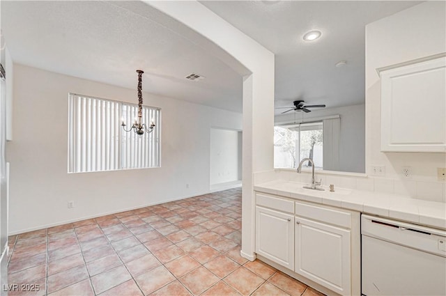 10612 Primrose Arbor Ave, Las Vegas, NV 89144 - kitchen featuring white dishwasher, tile counters, a ceiling fan, white cabinetry, and a chandelier