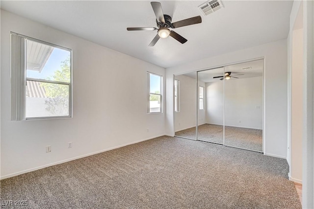 10612 Primrose Arbor Ave, Las Vegas, NV 89144 - unfurnished bedroom featuring carpet flooring, multiple windows, and a ceiling fan