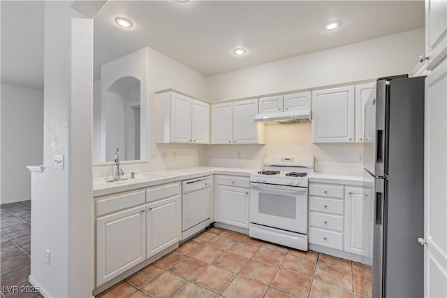 10612 Primrose Arbor Ave, Las Vegas, NV 89144 - kitchen featuring white appliances, white cabinetry, tile countertops, and recessed lighting