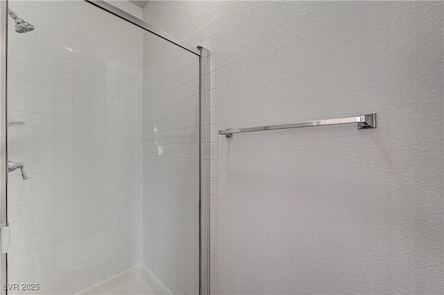 10612 Primrose Arbor Ave, Las Vegas, NV 89144 - full bathroom featuring a stall shower and a textured wall