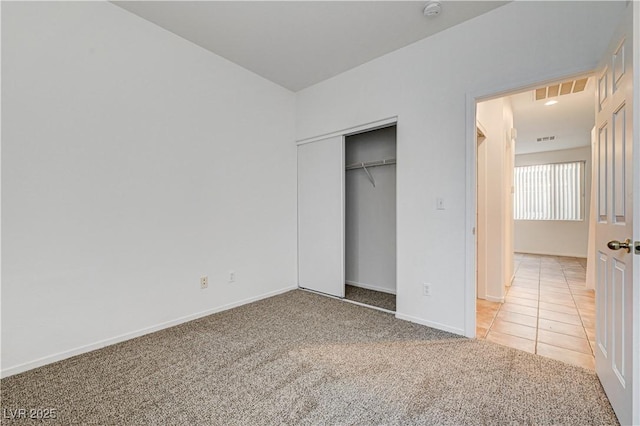 10612 Primrose Arbor Ave, Las Vegas, NV 89144 - unfurnished bedroom featuring light carpet, a closet, and light tile patterned floors
