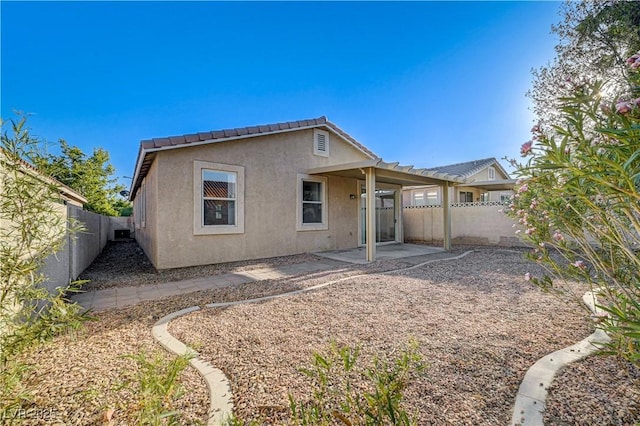 10612 Primrose Arbor Ave, Las Vegas, NV 89144 - rear view of house featuring stucco siding, a fenced backyard, and a patio area