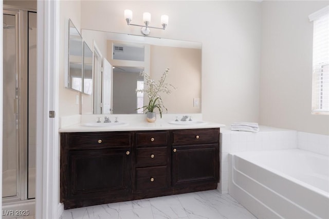 757 Roddenberry Ave, Las Vegas, NV 89123 - bathroom with double vanity, a bath, a shower stall, and marble look tiles