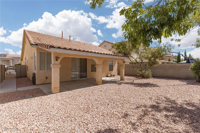 757 Roddenberry Ave, Las Vegas, NV 89123 - rear view of property with stucco siding, a tiled roof, a fenced backyard, and a patio area