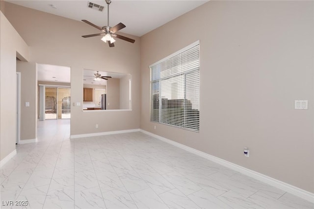 757 Roddenberry Ave, Las Vegas, NV 89123 - empty room featuring ceiling fan, light marble finish floors, and a high ceiling