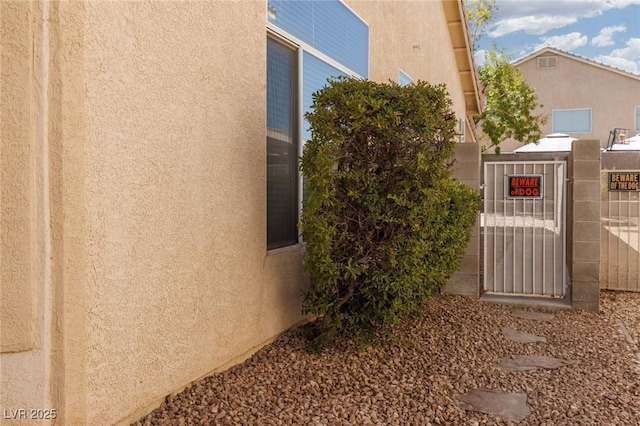 757 Roddenberry Ave, Las Vegas, NV 89123 - view of side of property featuring stucco siding and a gate