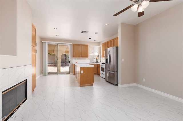 757 Roddenberry Ave, Las Vegas, NV 89123 - kitchen featuring stainless steel fridge, a ceiling fan, light marble finish floors, white range oven, and recessed lighting