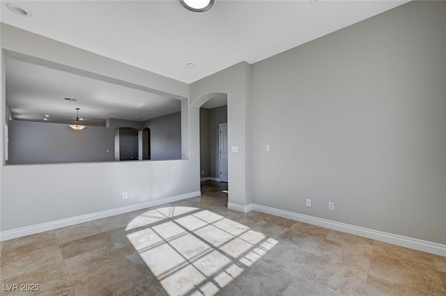 10518 Santerno St, Las Vegas, NV 89141 - empty room featuring arched walkways and baseboards