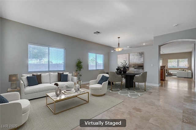 10518 Santerno St, Las Vegas, NV 89141 - living area featuring arched walkways and plenty of natural light
