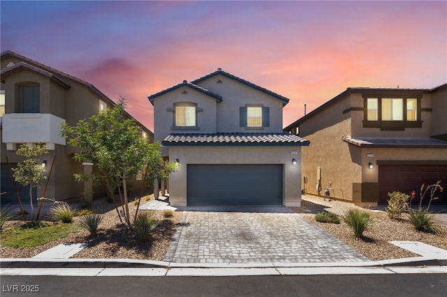 9237 Brayden Bay St, Las Vegas, NV 89178 - mediterranean / spanish house with stucco siding, decorative driveway, a tile roof, and an attached garage