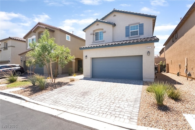 9237 Brayden Bay St, Las Vegas, NV 89178 - mediterranean / spanish home featuring decorative driveway, stucco siding, a tiled roof, and an attached garage