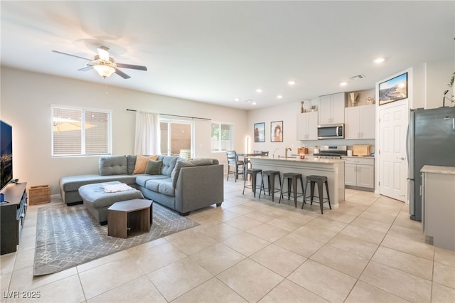 9237 Brayden Bay St, Las Vegas, NV 89178 - living area with light tile patterned floors, ceiling fan, and recessed lighting