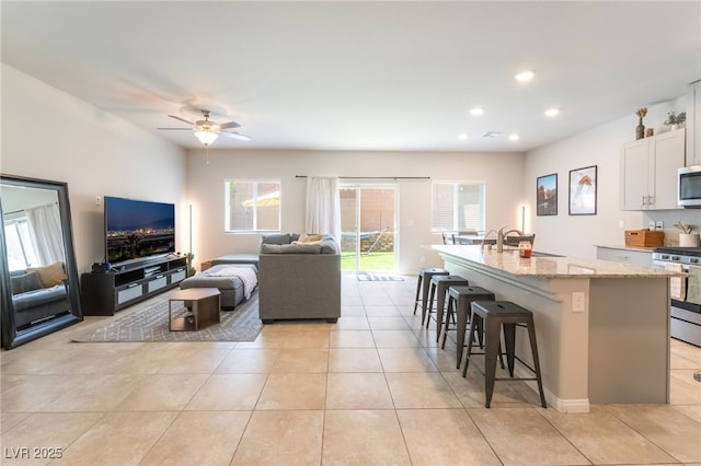 9237 Brayden Bay St, Las Vegas, NV 89178 - living room with ceiling fan, plenty of natural light, light tile patterned floors, and recessed lighting
