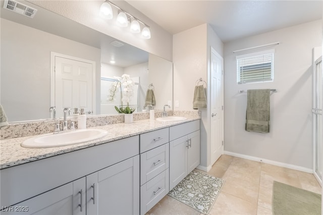 9237 Brayden Bay St, Las Vegas, NV 89178 - bathroom with double vanity, a stall shower, and tile patterned floors