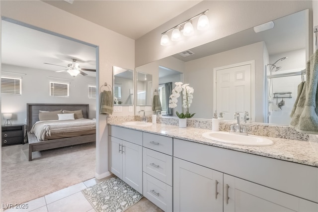 9237 Brayden Bay St, Las Vegas, NV 89178 - ensuite bathroom featuring double vanity, tile patterned floors, ceiling fan, and an enclosed shower