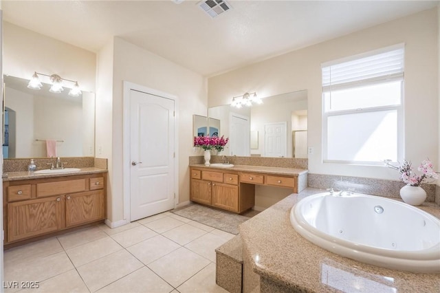 8929 Glenistar Gate Ave, Las Vegas, NV 89143 - bathroom featuring a jetted tub, tile patterned flooring, and two vanities