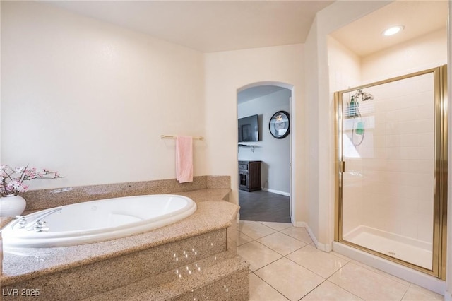 8929 Glenistar Gate Ave, Las Vegas, NV 89143 - bathroom with a bath, a shower stall, and tile patterned flooring