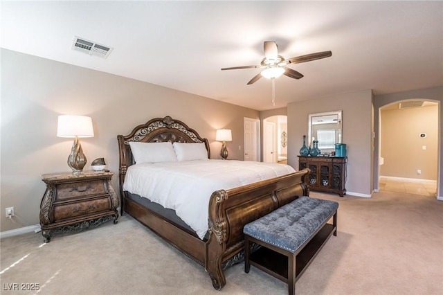 8929 Glenistar Gate Ave, Las Vegas, NV 89143 - bedroom with arched walkways, light carpet, ceiling fan, and ensuite bathroom