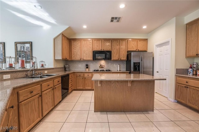 8929 Glenistar Gate Ave, Las Vegas, NV 89143 - kitchen featuring black appliances, a kitchen island, light tile patterned floors, tasteful backsplash, and recessed lighting
