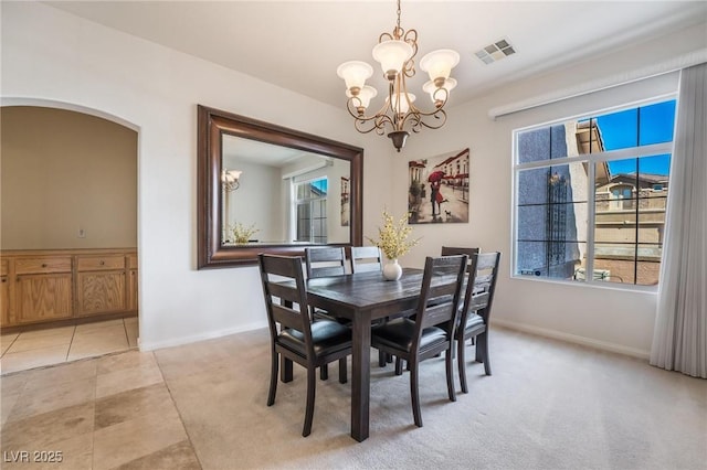 8929 Glenistar Gate Ave, Las Vegas, NV 89143 - dining room with a chandelier, plenty of natural light, arched walkways, and light tile patterned floors