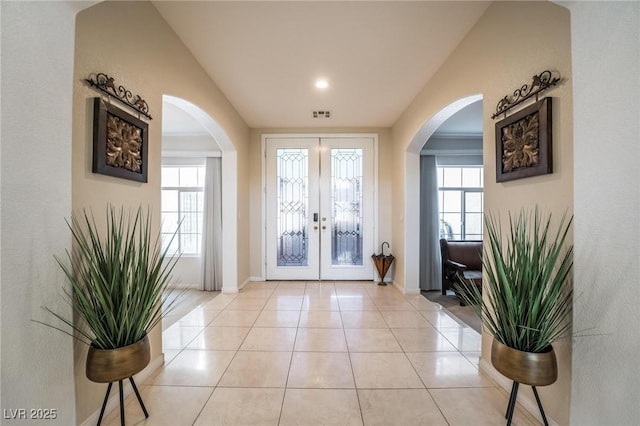 8929 Glenistar Gate Ave, Las Vegas, NV 89143 - foyer with french doors, arched walkways, and light tile patterned floors