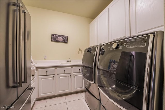 8929 Glenistar Gate Ave, Las Vegas, NV 89143 - laundry area with light tile patterned floors, separate washer and dryer, and cabinet space