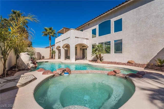 8929 Glenistar Gate Ave, Las Vegas, NV 89143 - view of pool with a pool with connected hot tub, a fenced backyard, and a patio
