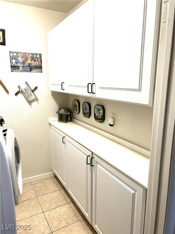 4816 Fiesta Lakes St, Las Vegas, NV 89130 - laundry room featuring cabinet space and light tile patterned flooring