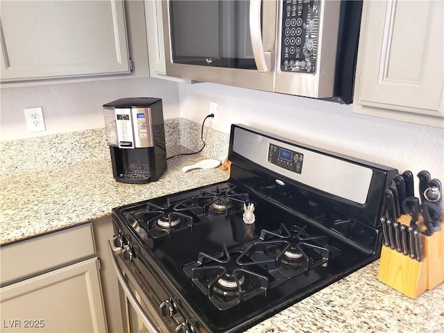 4816 Fiesta Lakes St, Las Vegas, NV 89130 - kitchen with appliances with stainless steel finishes and light stone countertops
