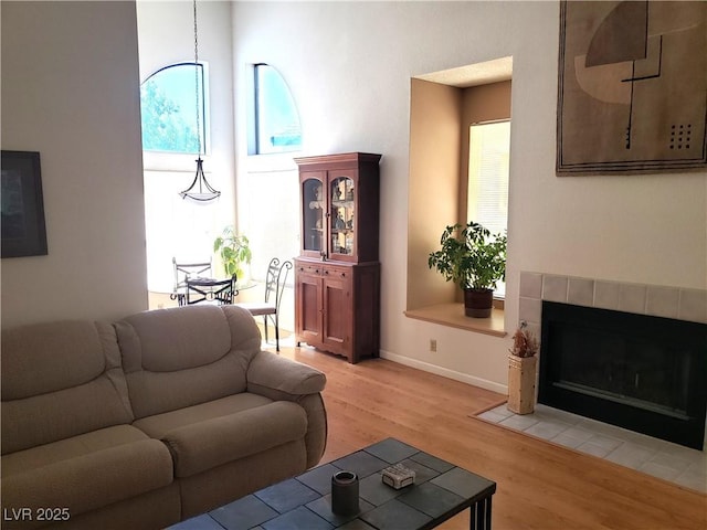 4816 Fiesta Lakes St, Las Vegas, NV 89130 - living room featuring light wood-style flooring and a tiled fireplace