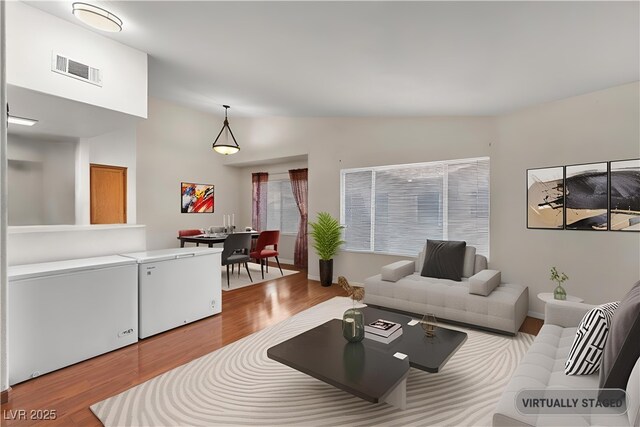 350 S Durango Dr Unit 202, Las Vegas, NV 89145 - living area featuring wood finished floors and vaulted ceiling